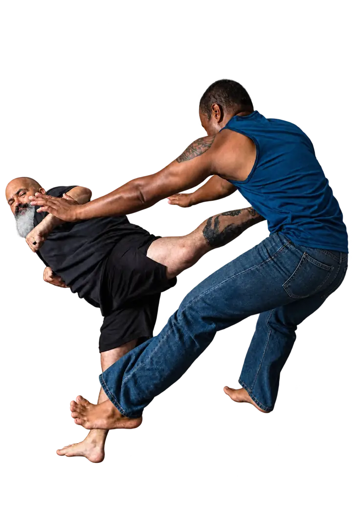 Coach Jeff demonstrating a kick to his training partner’s torso