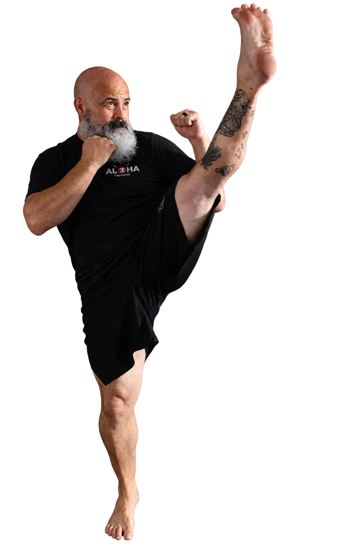 Coach Jeff demonstrating a high kick with his hands in guard
