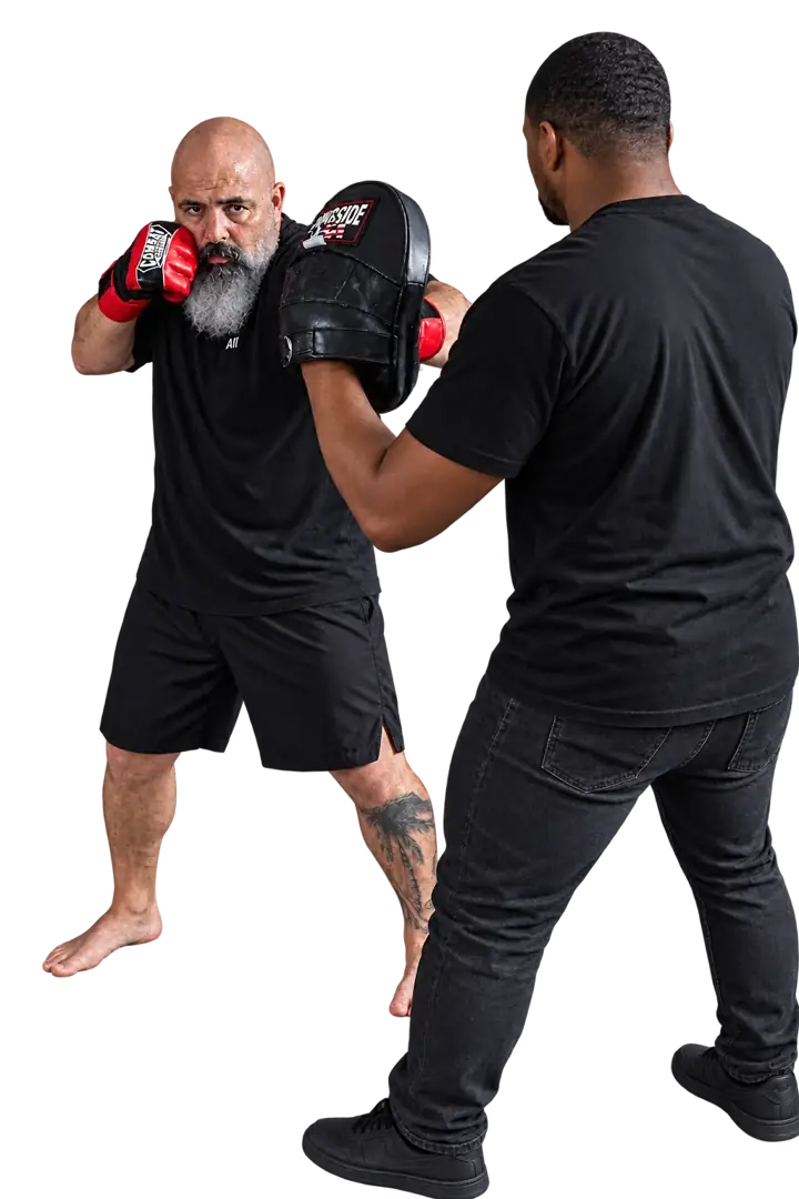 Coach Jeff practicing a straight strike toward a focus mitt