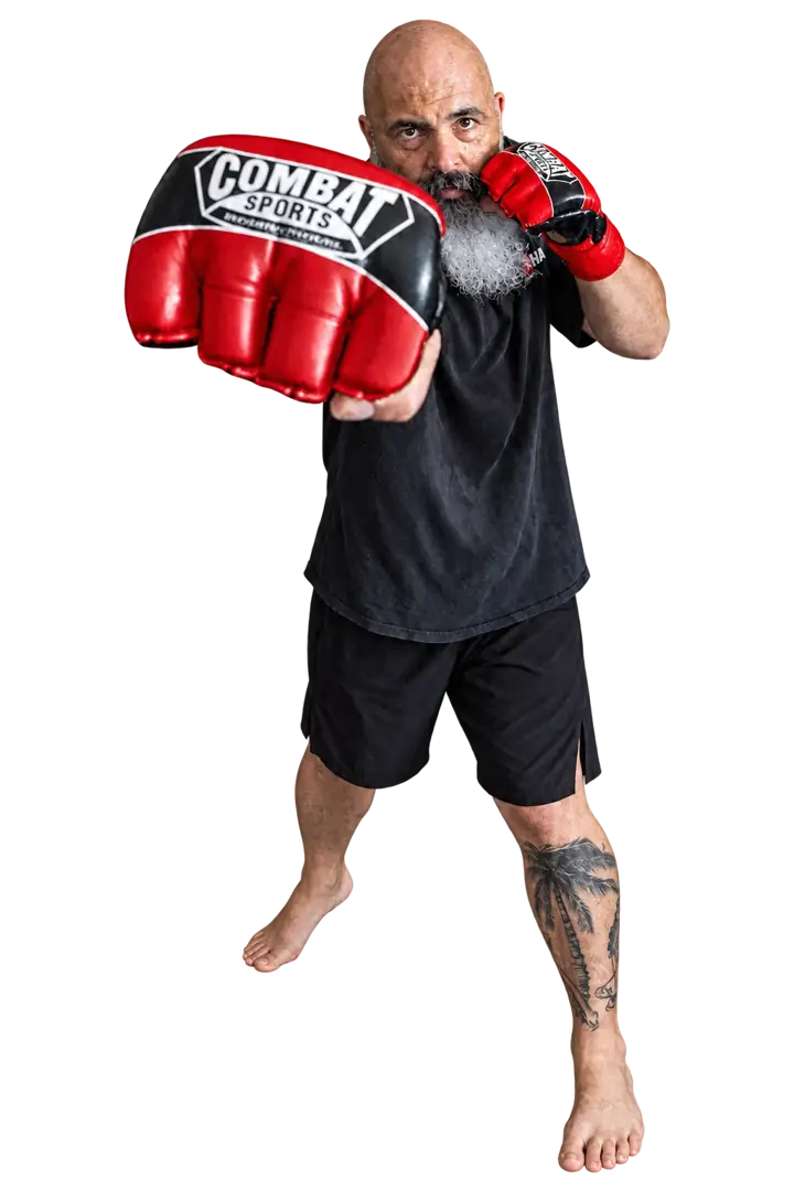 Coach Jeff demonstrating a straight strike with red boxing gloves