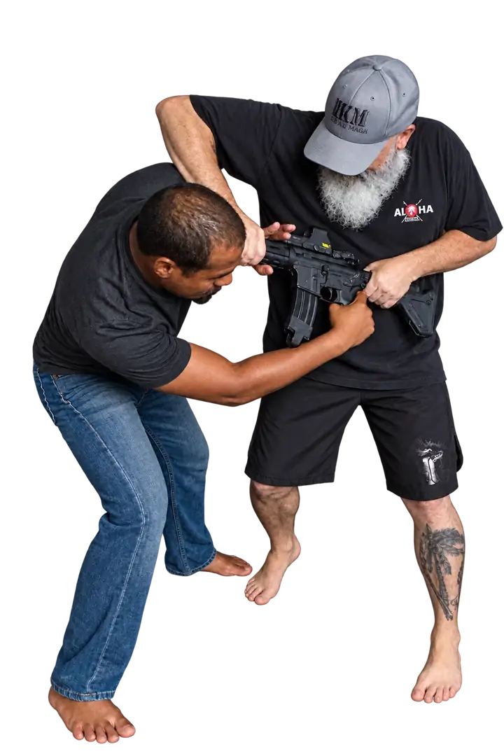 Coach Jeff and a training partner demonstrating a firearm threat scenario